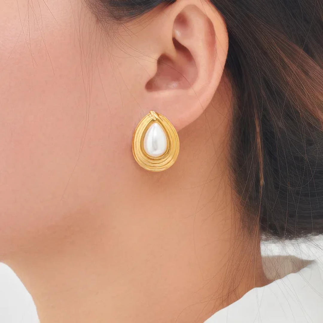 Model wearing TISA Nyx Pearl Drop Earrings – elegant pearl and gold design, hypoallergenic and waterproof jewelry