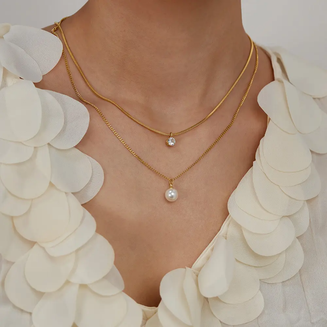 Model wearing TISA’s Double Layered Zircon Necklace – elegant dual-layer gold chain with pearl and solitaire CZ, ideal for office to party wear.