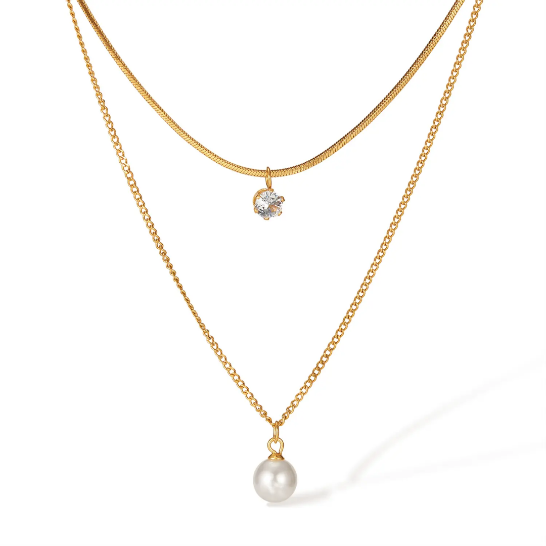 Double Layered Zircon Necklace by TISA – 18K gold-plated stainless steel, waterproof and hypoallergenic, with a pearl and solitaire zircon pendant.