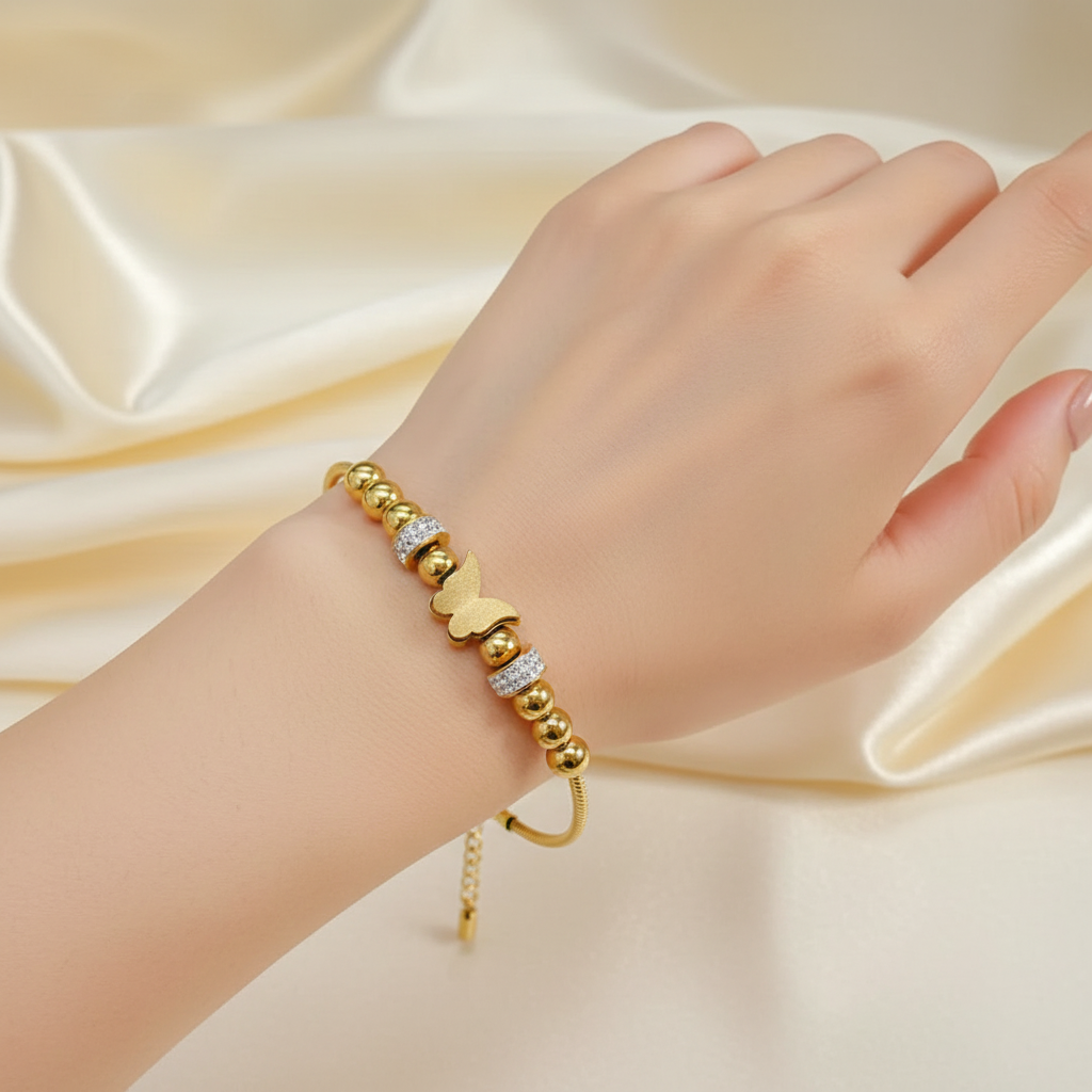 18k Gold plated bracelet with heart-shaped beads on a hand against a satin background
