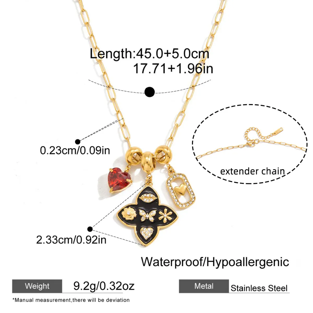 Gold necklace with heart and clover charms, showing measurements and extender chain on a white background.