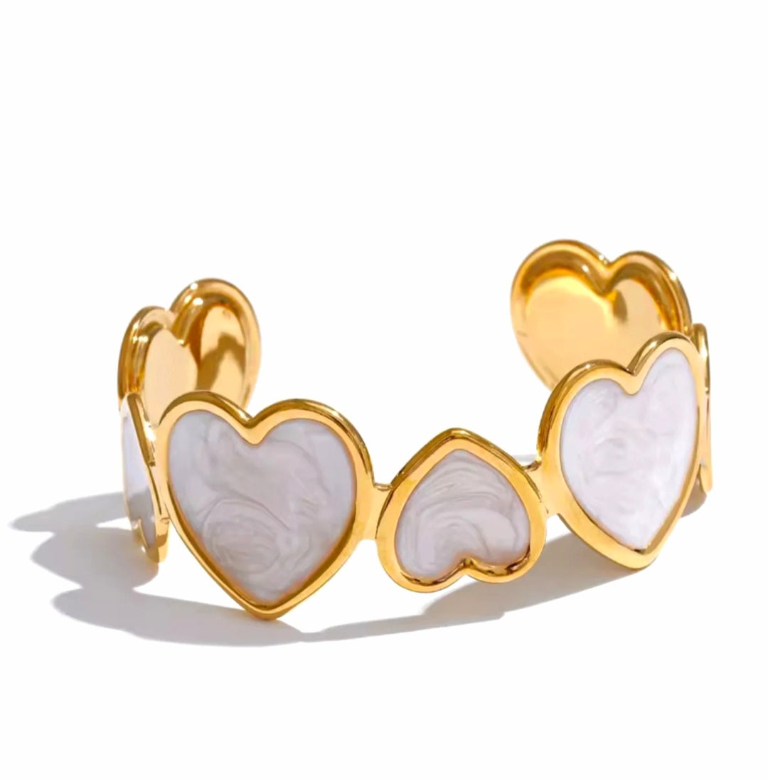 Minimalist heart-shaped stainless steel enamel bangle cuff8 with and open-ended design, blending elegance and modern charm.