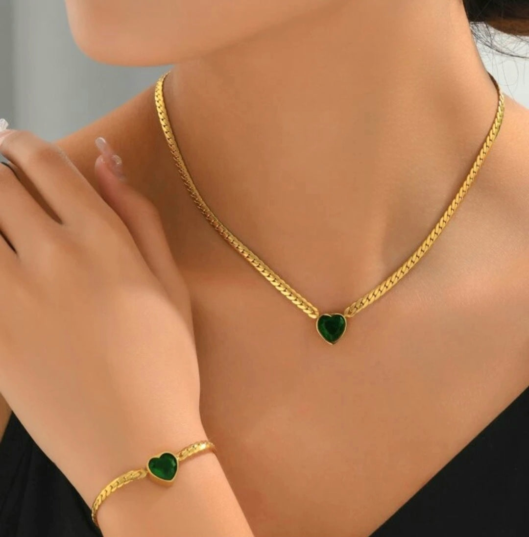 Model wearing TISA Viper's Heart Luxe Set – waterproof 18k gold necklace and bracelet with emerald stone, hypoallergenic and non-tarnish.