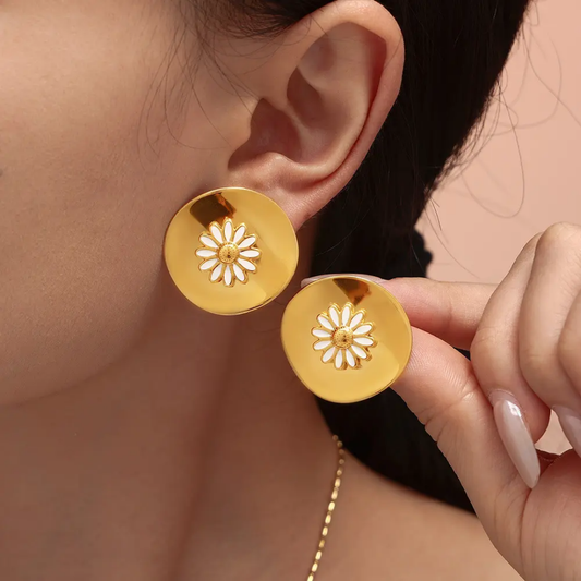 Model wearing TISA’s Daisy Flower Earrings – lightweight daisy design 18k gold plated and waterproof ideal for beachwear or casual outings.