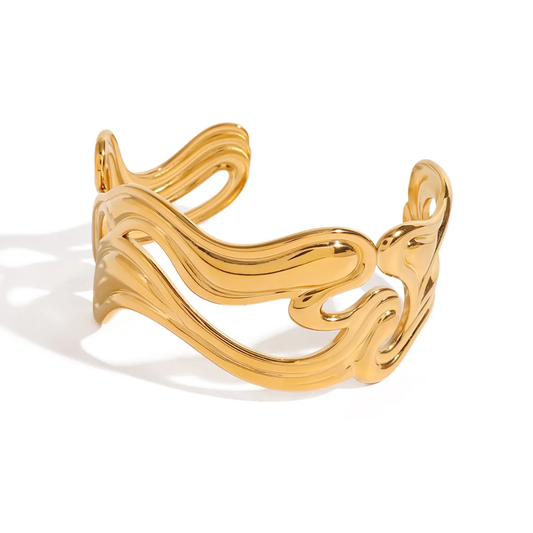 Flux Abstract Bangle Cuff by TISA – molten wave design in 18K gold-plated stainless steel, bold sculptural look, waterproof and tarnish-resistant.
