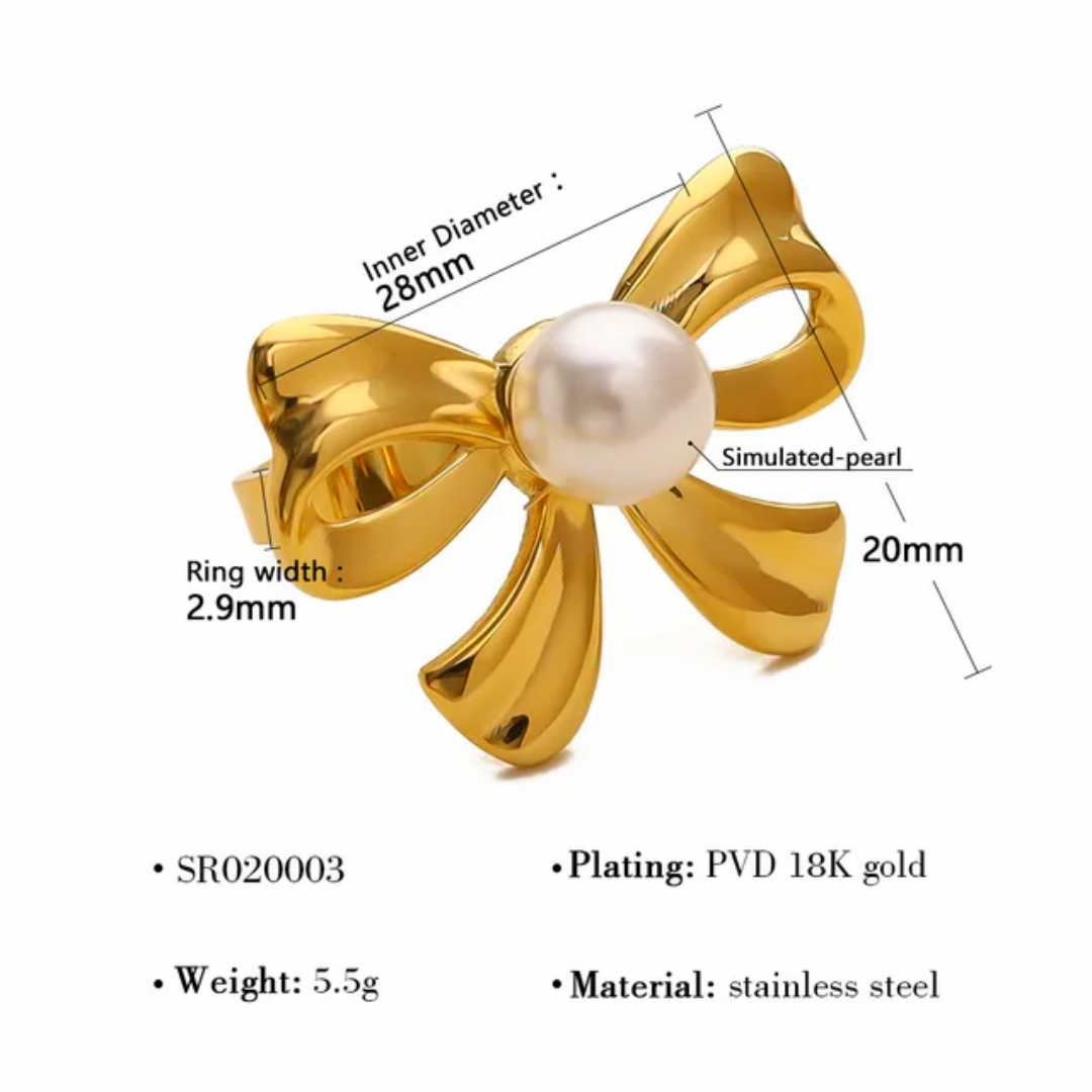 Gold bow-shaped ring with pearl center and measurement details on a white background