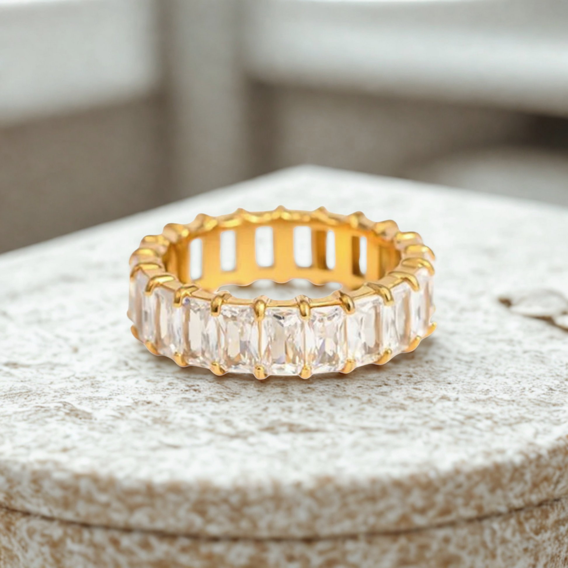 Clear cubic zirconia baguette eternity ring in 18K gold-plated stainless steel, hypoallergenic waterproof anti-tarnish jewelry.