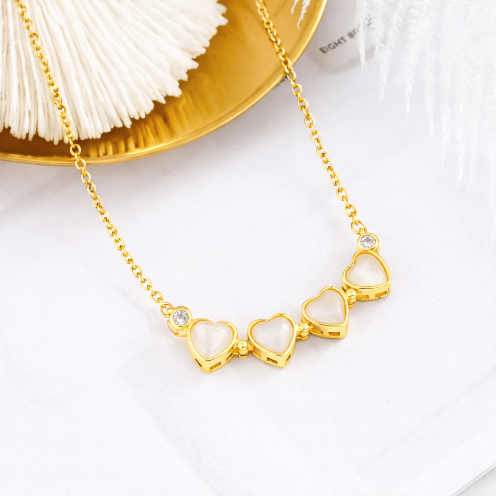 18k Gold magnetic necklace with heart-shaped pendant on a white surface 