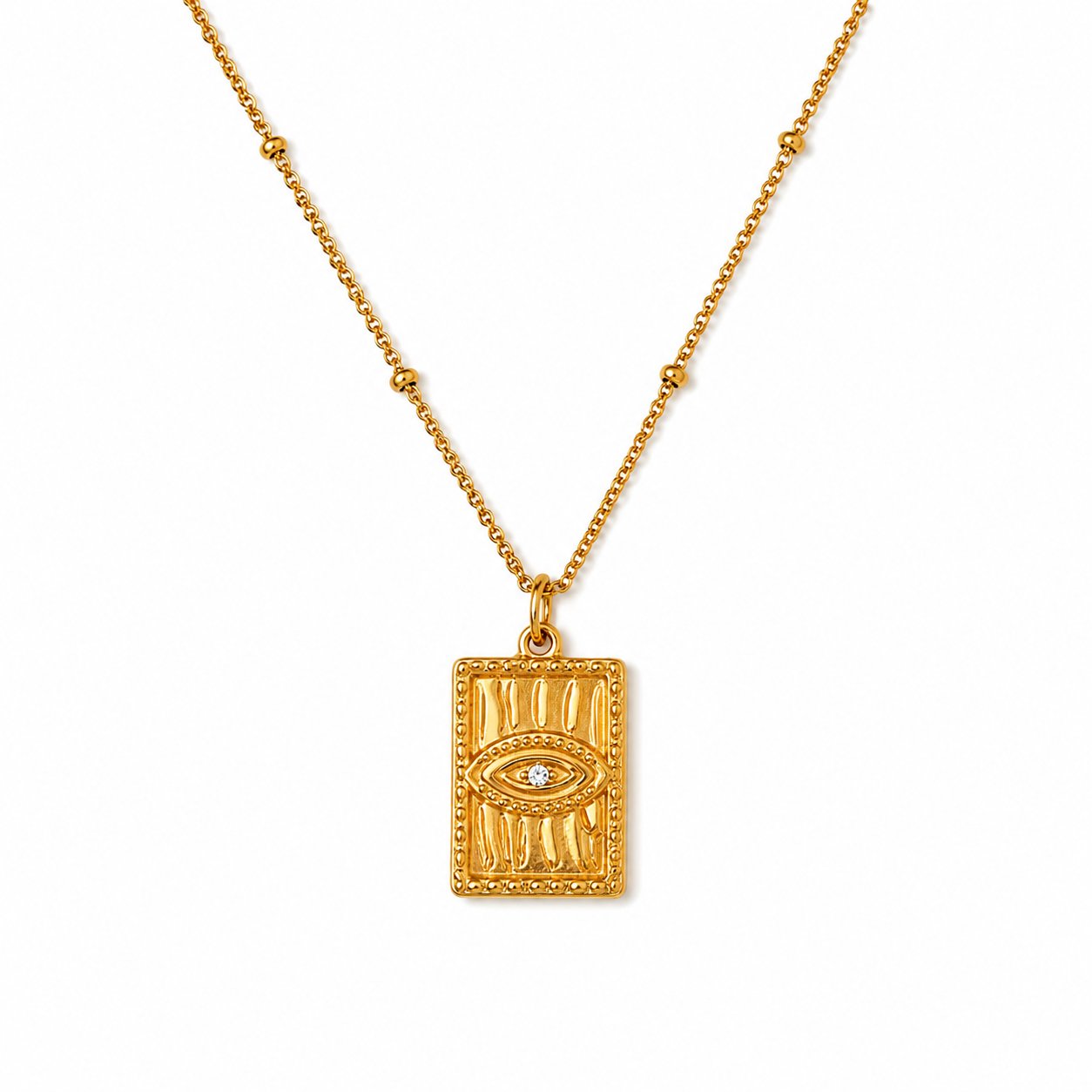 Tisa 18k gold-plated rectangular pendant necklace featuring a raised evil eye motif with a small clear zircon gemstone at the center, suspended from a delicate gold chain on a plain white background.