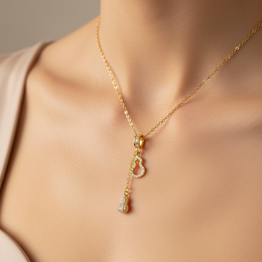 18k Gold plated necklace with a zircon studded guitar pendant on a neutral background