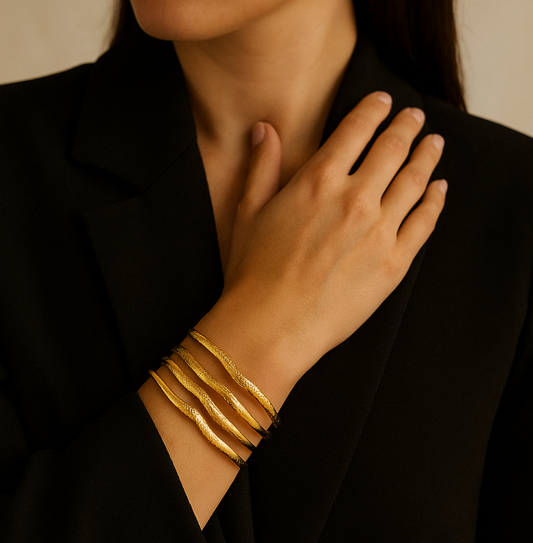 Luna Ridges Gold Bangle Cuff worn by model, its 18k gold plated stainless steel, waterproof & hypoallergenic by Tisa