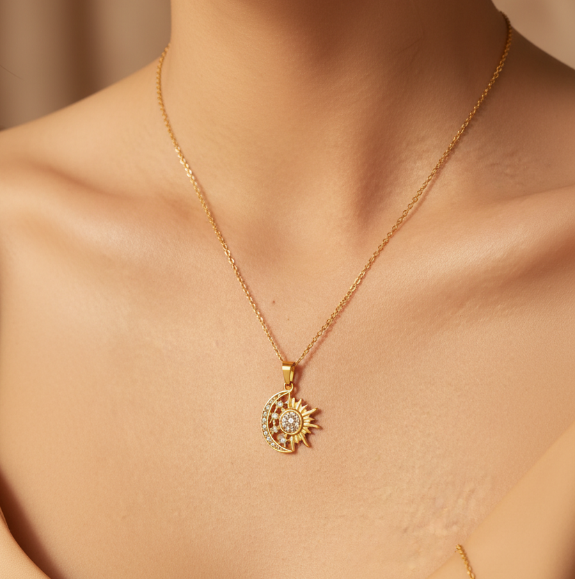Tisa 18k Gold-plated crescent moon and sun pendant necklace with small zircon stones, worn on a model's neck.