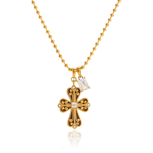 Gold necklace with a cross pendant on a white background