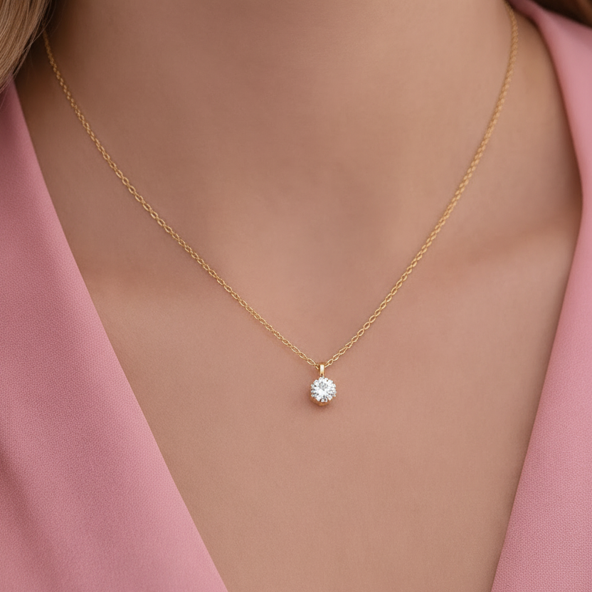 18k Gold plated necklace with a zircon pendant worn by a model in a pink outfit.