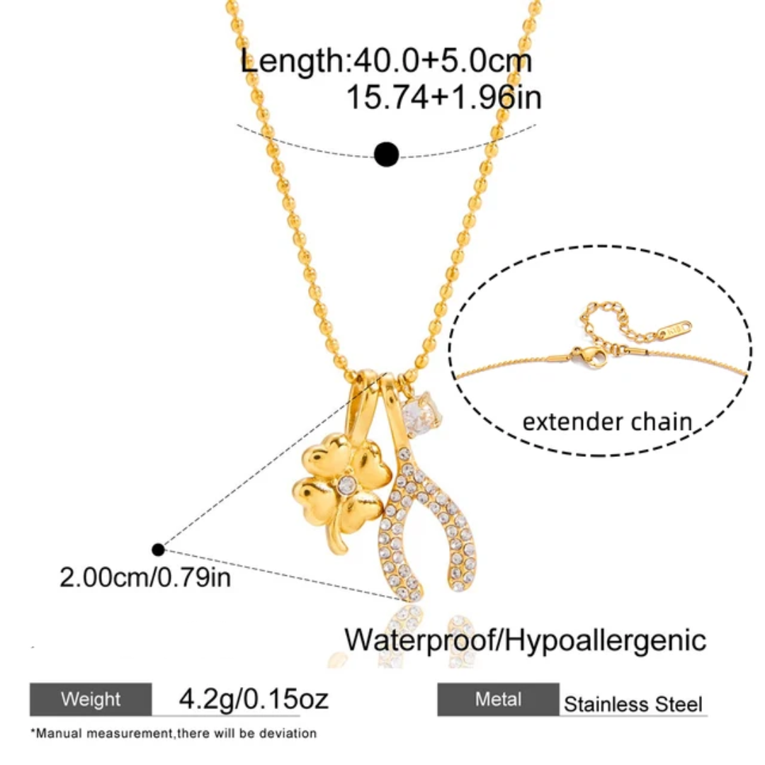 Tisa 18k Gold-plated stainless steel charm necklace with a four-leaf clover, a zircon wishbone and a zircon solitaire shown with measurement annotations, weight 4.2g, and an inset detail of the extender chain.