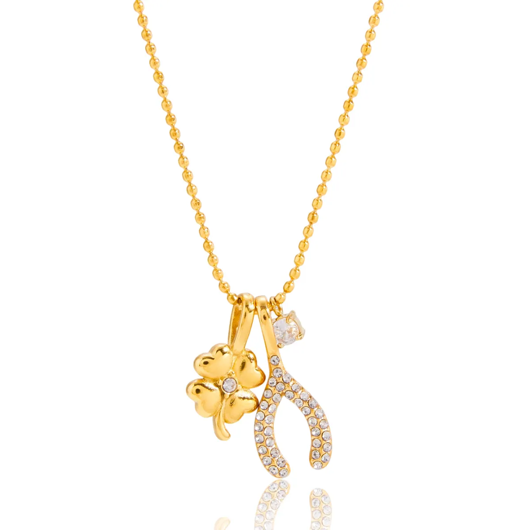 18k Gold played necklace with wishbone, clover and zirconia charms on a white background