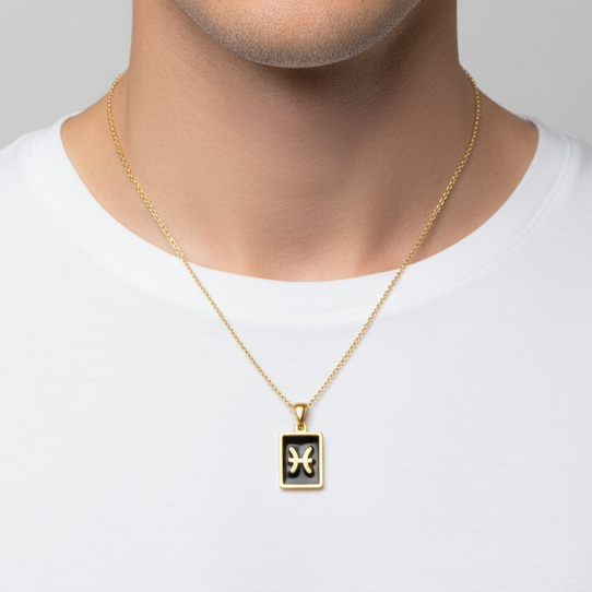 Male model wearing a 18k gold plated stainless steel necklace with a black zodiac pendant on a plain background.