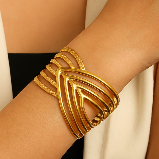 Model wearing Criss-Cross Gold Bangle Cuff by TISA – statement open cuff in 18K gold-plated stainless steel, styled for a bold, modern look.