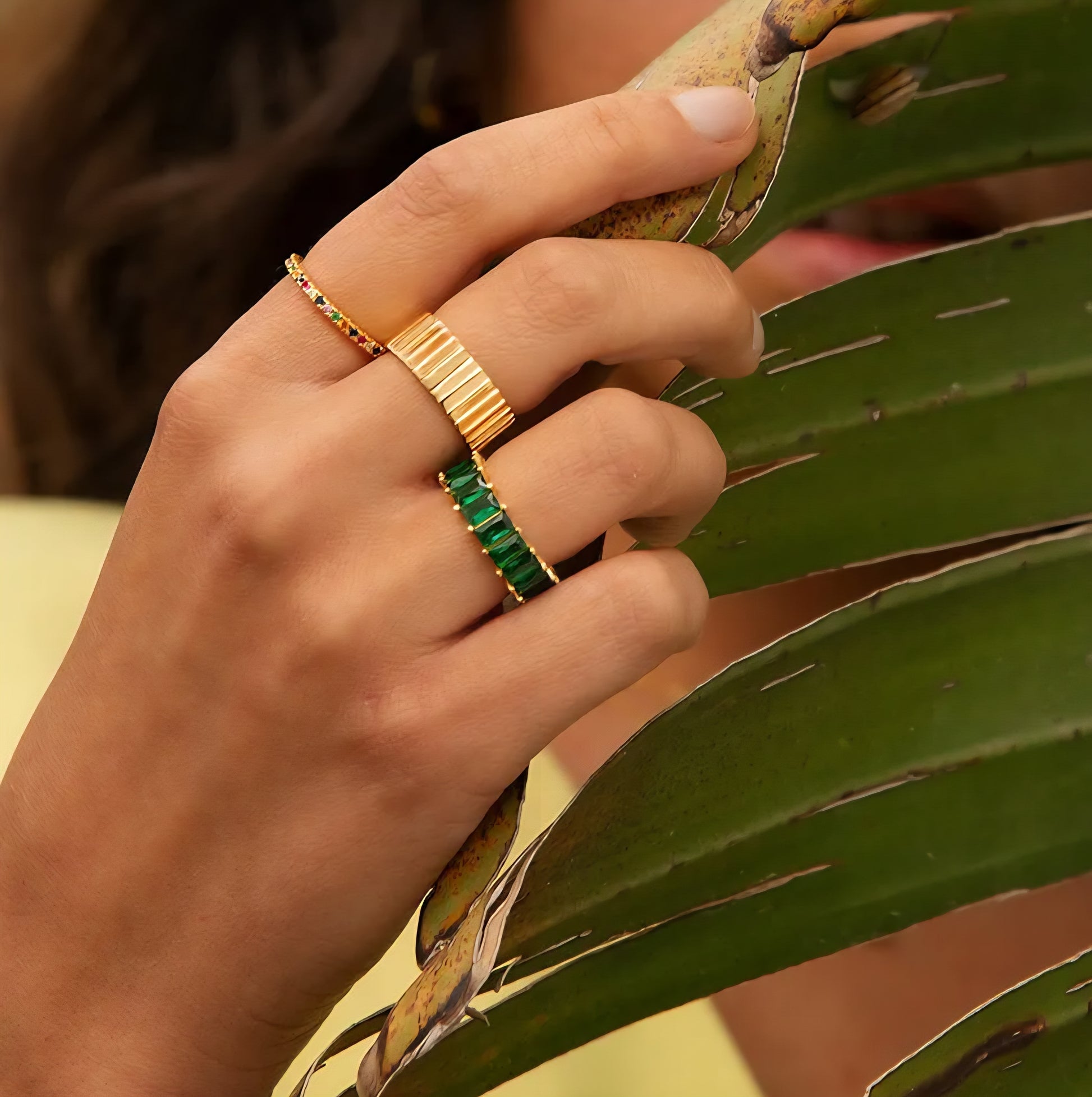 Emerald green cubic zirconia baguette eternity ring in 18K gold-plated stainless steel, hypoallergenic waterproof anti-tarnish.
