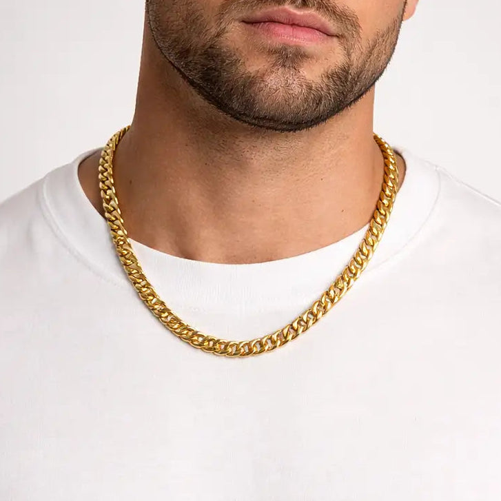 Male model wearing Tisa 18k gold plated 8mm cuban chain necklace on a white background.